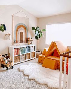 a child's room with white carpet, bookshelf and toys on the floor