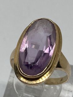 ESTATE FIND A Stunning Vintage Chunky 9Ct Yellow Gold Bezel Set Large Natural Royal Purple Amethyst Statement Ring Fully Hallmarked in Birmingham England  Marked 375 for 9Ct Gold Makers Mark W&G Size L Ring head size 20mm x 10mm Weight 3.09 grams  Presented in very good condition Oval Amethyst Ring For Formal Occasions, Vintage Oval Sapphire Ring, Oval Hallmarked Amethyst Ring For Formal Occasions, Gold Oval Heirloom Amethyst Ring, Gold Oval Amethyst Heirloom Ring, Formal Hallmarked Oval Amethyst Ring, Heirloom Gold Oval Amethyst Ring, Luxury Elegant Amethyst Ring With Bezel Setting, Heirloom Gold Amethyst Oval Ring