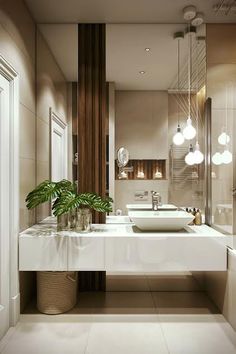 a modern bathroom with two sinks and mirrors