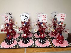 a table topped with cards and vases filled with flowers