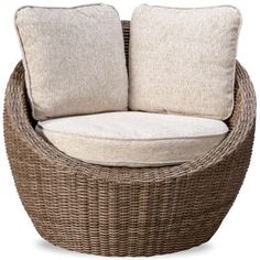 a brown wicker chair with two pillows on it's back and one pillow in the middle