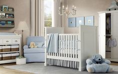 a baby's room with a crib, dresser and chair in it is shown