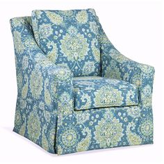 a blue and green chair with an ornate pattern on the armrests, sitting in front of a white background