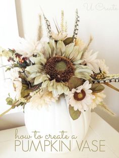 a white vase filled with flowers on top of a table