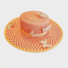 A hand shaped tangerine and natural buntal straw summer hat dotted with glittery butterflies. The hat will fit a head size of 22.5". This is ready to be shipped or you can order one to your own specifications. Orange Straw Hat For Spring Vacation, Spring Vacation Orange Straw Hat, Adjustable Orange Straw Hat For Summer, Adjustable Orange Straw Hat With Curved Brim, Handmade Orange Hat For Spring, Spring Orange Handmade Hats, Orange Adjustable Brimmed Straw Hat, Orange Brimmed Straw Hat With Adjustable Fit, Adjustable Brimmed Orange Straw Hat