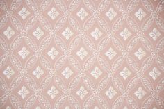 an old fashioned wallpaper pattern with white flowers on pink and beige background stock photo