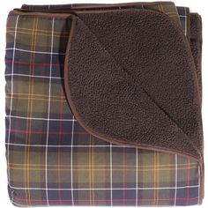 a blanket with a brown and green plaid design on it, folded up in front of a white background