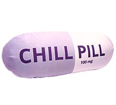 a pillow that has the words chill pill printed on it, in purple and white