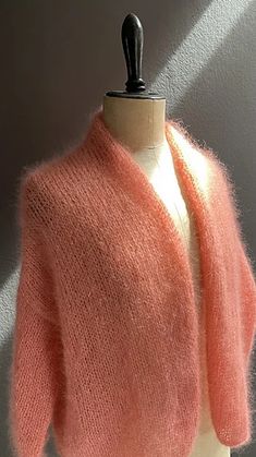 a mannequin with a pink sweater on it