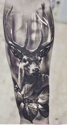 a man's leg with a deer and flowers on it