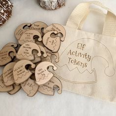 a bag with wooden cutouts on it next to some cookies and other items that include an activity token