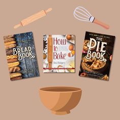 three cookbooks and a whisk sitting on top of a table next to a bowl