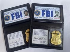 three different id badges are placed next to each other on black leather wallets with gold and silver details