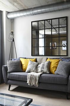 a living room filled with furniture and a large mirror