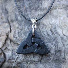 "This unique and intricate hand-carved Irish Bog Oak Celtic pendant will be made for you, or a loved one, in my studio on the West of Ireland. Bog Oak comes from ancient forests that once covered Ireland. Huge oaks have been buried in peat bogs and preserved from decay by the acidic and anaerobic bog conditions, sometimes for hundreds or even thousands of years. The wood is usually stained black by tannin dissolved in the acidic water. Bog-wood represents the early stages in the fossilization of Engraved Spiritual Black Jewelry, Traditional Black Engraved Necklace, Black Etched Jewelry For Gifts, Black Etched Jewelry For Gift, Engraved Black Spiritual Jewelry, Traditional Black Etched Jewelry, Black Artisan Engraved Jewelry, Symbolic Black Etched Jewelry, Artisan Black Engraved Necklace