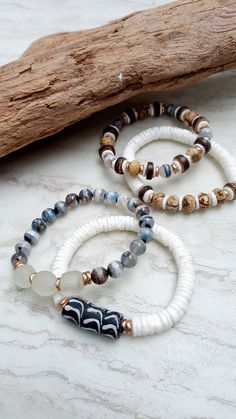 Soft, serene, cozy, and beachy. Beautiful beige, gray, white, and ecru in these mixed medium stack bracelets. Black and white handmade recycled glass, crisp white shell disks, faceted Picture Jasper rondelles, stunning Tibetan Agate in gradient gray, coconut disks, African recycled glass, and mixed metals. Unique and stunning. The item/s pictured is the item you will receive. Bracelets is 7.0" to 7.5" in length. HavSolStudio on ETSY | Mixed media . Earthy elegance . Great texture . Beach inspire Bohemian White Bracelets For Everyday, White Natural Stones Bracelets For Beach, White Natural Stones Bracelets For The Beach, White Stacked Beaded Bracelets, White Bohemian Stackable Bracelets, Bohemian White Stackable Bracelets, White Stacked Beaded Bracelets For The Beach, White Stackable Bracelets For Beach, Bohemian White Stretch Bracelet With Natural Stones