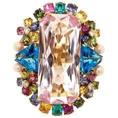 Wow! A guaranteed stunner! This large cocktail ring features a large rectangular shaped pink kunzite weighing 30 carats. Around the center stone is a bouquet of multicolored gemstones which include two fine paraiba tourmalines on the top and bottom of the ring. Adding to that there are 4 round brilliant cut diamonds, 4 natural pearls, 2 larger blue topaz on the sides, and multicolored sapphires all round the rest of the piece. Made in 18k yellow gold it is guaranteed that another one of these ri Birth Stones, Pink Kunzite, Rainbow Jewelry, Gold Cocktail Ring, Gold Cocktail, Colored Gems, Crown Jewels, Women Diamond, Antique Diamond