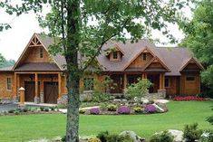 a large house surrounded by trees and flowers