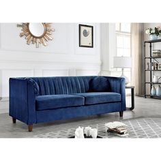 a blue velvet couch in a living room