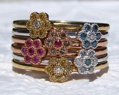 "Here's a colorful and sparkly flower stacking ring from my \"Wildflowers\" collection. It will be custom-made for you in any combination of colorful gems and diamonds, in any gold color and in your ring size. Great way to add some color to your wedding set or stack, or enjoy on its own as a right hand ring. The listing is for ONE stacking ring (with one flower). You can stack multiple rings to mix and match the colors, or stack them with the other stacking rings from my \"Wildflowers\" collecti Fine Jewelry Multi-stone Stackable Rings With Round Band, Heirloom Multi-stone Stackable Rings For Wedding, 14k Gold Multi-stone Stackable Rings, Multicolor Multi-stone Stackable Fine Jewelry Rings, Fine Jewelry Stackable Rings With Multi-stone Cubic Zirconia, Wedding Band With Diamonds, Floral Wedding Band, Band With Diamonds, Floral Wedding Bands