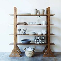 a wooden shelf with bowls and plates on it