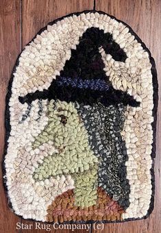 a round rug with an image of a woman wearing a witches hat on top of it