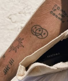 a man's arm with tattoos on it and the words i love you written in cursive writing