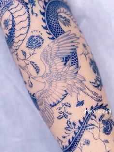 the arm is covered with blue and white tattoos on it's arms, which are decorated