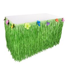 a table with grass and flowers on it