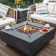 a fire pit sitting on top of a wooden deck