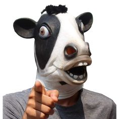 a person wearing a cow mask and pointing at the camera with their hand in front of his face