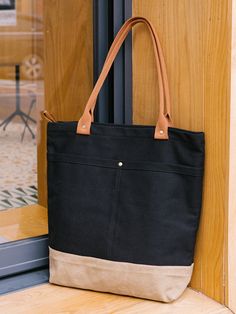 Overview： Design: Women Canvas Shopper Tote Bags Canvas Tote Shoulder Bag Handbag for MensIn Stock: Ready to Ship (2-4 days)Include: Only BagCustom: NoColor: Black&Khaki Leather: CanvasMeasures: 40cm x 39cm x 13cm Weight: 0.45kgSlots: 1 zipper slot, 1 phone slot, 1 wallet slot, Accessories(option): NoneStyle: Women Canvas Shopper Tote Bags Canvas Tote Shoulder Bag Handbag for MensVery durable (At least 5 Years) and it should last a life time Description: Upgrade your everyday must-haves with the enduring sophistication of our Black & Khaki Canvas Tote Bag. Designed with meticulous care, this adaptable piece effortlessly shifts from errands to the office to globetrotting, all with timeless grace. Sized at 40cm x 39cm x 13cm, this capacious tote offers generous space for your daily essential Black Bag With Zipper Pocket For Everyday Use, Black Canvas Bag With Leather Handles, Black Canvas Shoulder Bag For Travel, Black Canvas Satchel Shoulder Bag, Black Satchel Canvas Bag For On-the-go, Black Canvas Satchel For On-the-go, Black Canvas Bag With Zipper Pocket For On-the-go, Black Canvas Satchel Bag With Zipper Pocket, Black Canvas Bag With Leather Handles For On-the-go