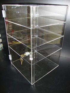 a clear acrylic display case on a black table