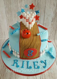 a birthday cake with bowling pins and balls on it