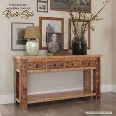 a wooden table with two drawers and pictures on the wall