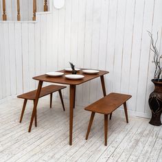 a wooden table with two benches next to it