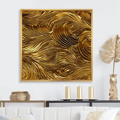 a living room with white couches and gold wall art