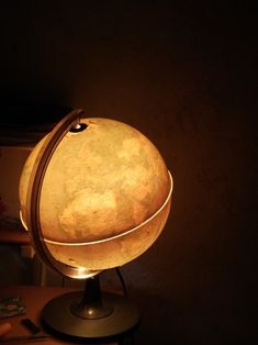 an illuminated globe sitting on top of a table