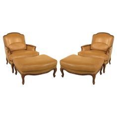 a pair of brown leather chairs and ottomans