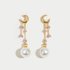 The moon glows softly every night in the sky. It serves as a reminder that no matter how dark it may appear to be, hope & light can be found anywhere. Keep these beautiful earrings close to chase your dreams and follow your heart always. 18K gold plated Imitation pearl, crystal Size: 1.1in x 0.2in Pushback stud closure Hypoallergenic, lead & nickel free If you aren't in LOVE with your purchase, please let us know within 30 days of receiving your item, and you'll receive a stress-free refund. Elegant Moon Shaped Earrings With Sun And Moon Design, Elegant White Moon Phase Earrings, Elegant Hypoallergenic Moon Shaped Earrings, Elegant Sun And Moon Design Drop Earrings, Celestial Moon Phase Moon Earrings, Hope Light, Chase Your Dreams, Pearl Crystal, Moon Glow