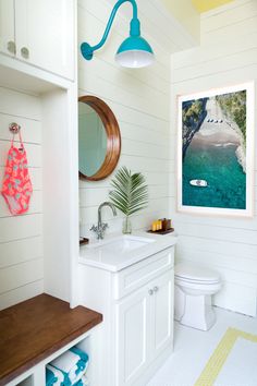 a bathroom with a sink, toilet and mirror