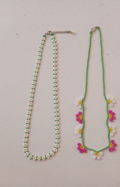 two beaded necklaces with flowers on them