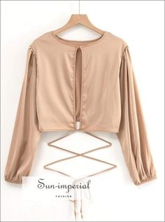 Women Champagne Satin Long Sleeve Tie Waist Crop top with Cut out detail Cheap Chic Crop Top Blouse, Affordable Crop Top For Party Season, Luxury Long Sleeve Chic Crop Top, Cheap Cream Tops For Festival, Luxury Crop Top For Spring Party, Cheap Elegant Spring Crop Top, Luxury Seamless Tops For Party, Luxury Elegant Long Sleeve Crop Top, Luxury Elegant Long Sleeve Cropped Shirt