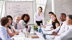 a group of business people sitting around a conference table