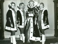 black and white photograph of three women dressed in christmas costumes, standing next to each other