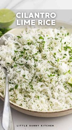 a white plate topped with rice and garnished with cilantro limes