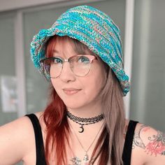 a woman wearing glasses and a knitted hat looks off to the side with her hand on her hip