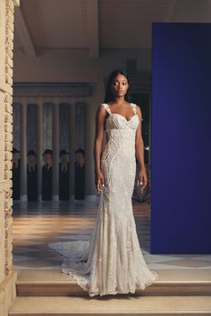 a woman in a wedding dress standing on some steps