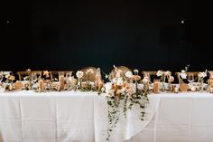 the table is set with flowers and candles