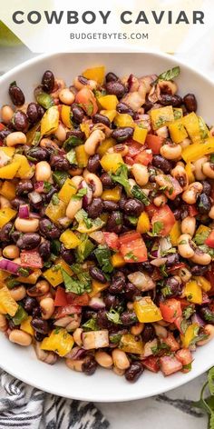 a white bowl filled with black - eyed beans and vegetables